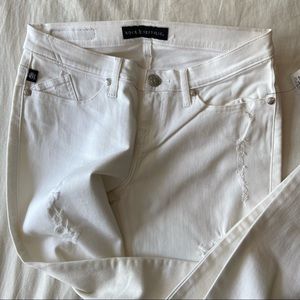 Distressed white jeans
